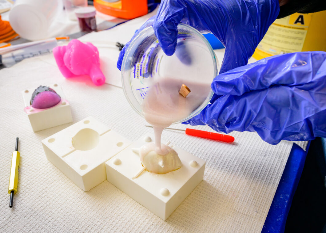 <em>Granados pours silicone into a heart mold that he 3D printed as part of on his project to create a silicone heart model that pumps fluids using actuators like the muscle in the heart.<br>Photo by Fred Zwicky.</em>