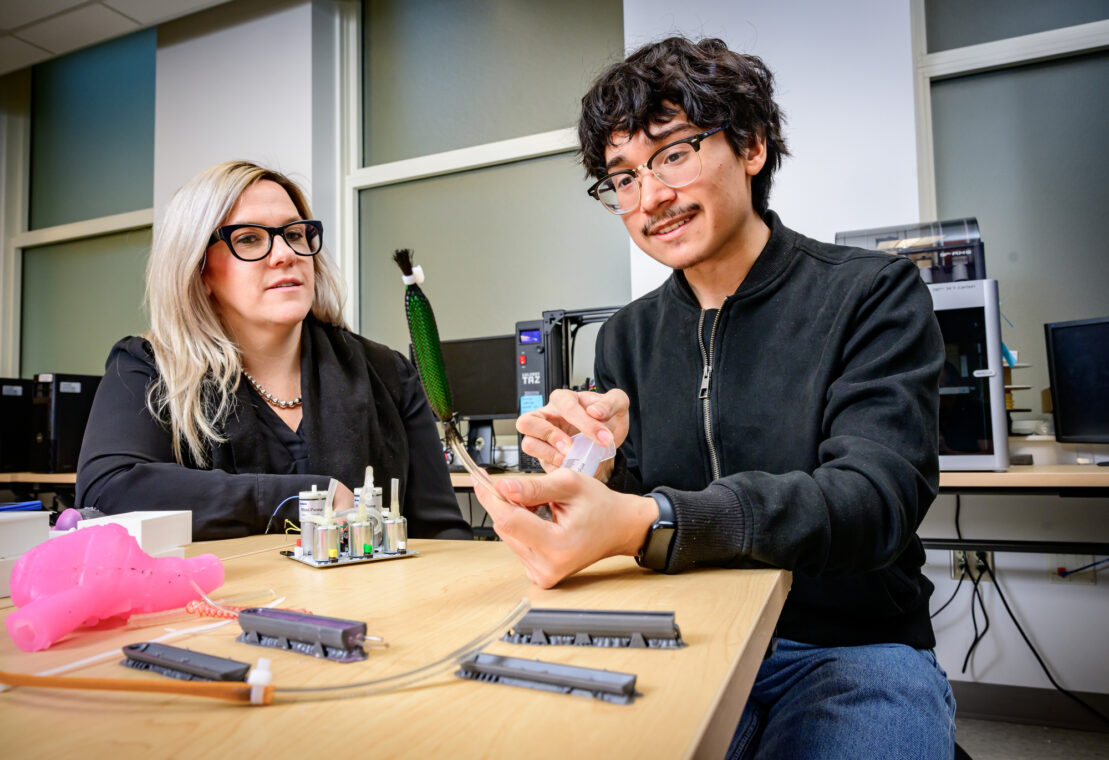 Bioengineering professor Holly Golecki, left, works with Andy Granados, a participant in the First-Generation Scholars Research Program, designing an actuator with a balloon inside polyester mesh in order to create a silicone heart model that pumps fluids. Photo by Fred Zwicky.