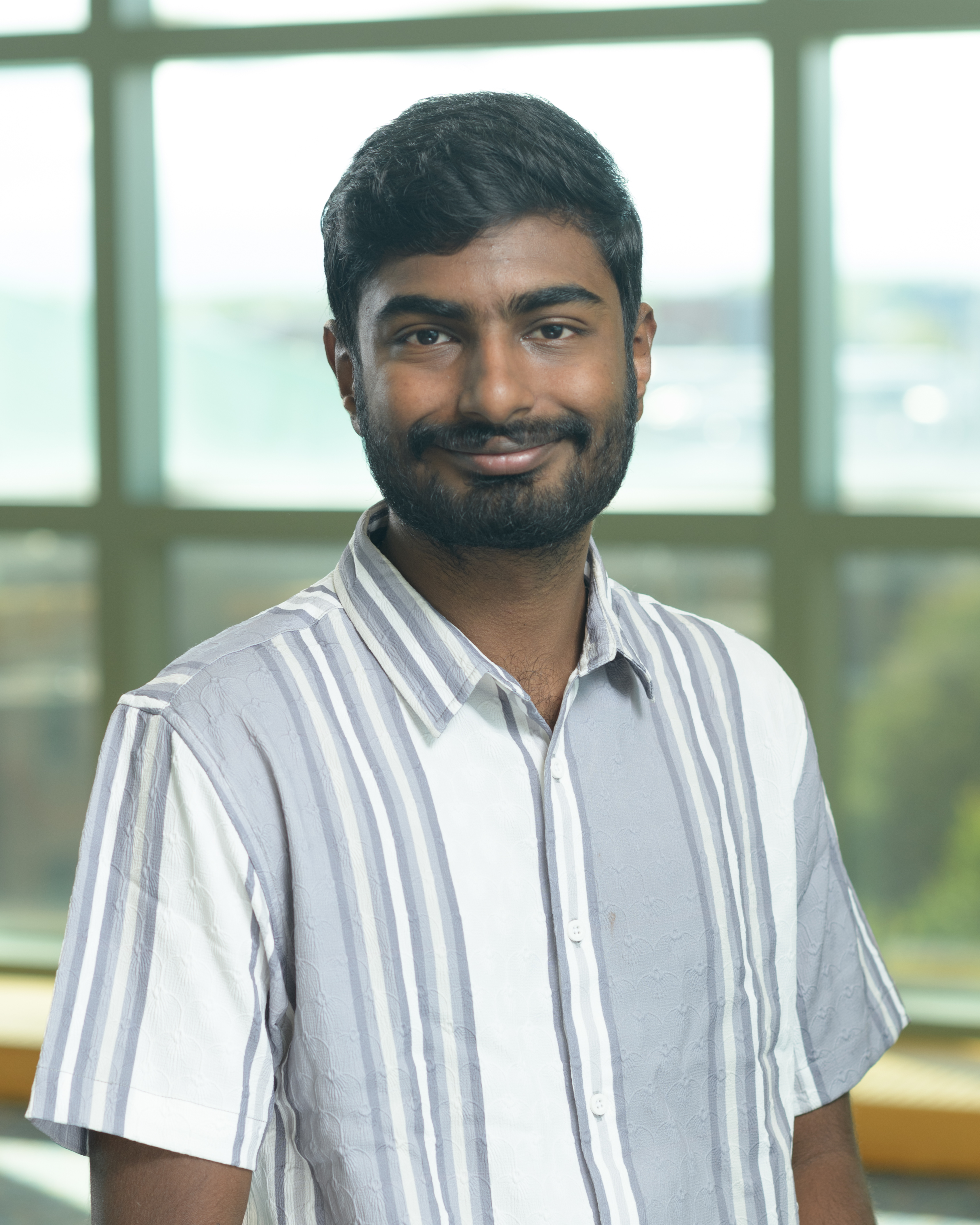 Dhanush Gandavadi smiles at the camera.