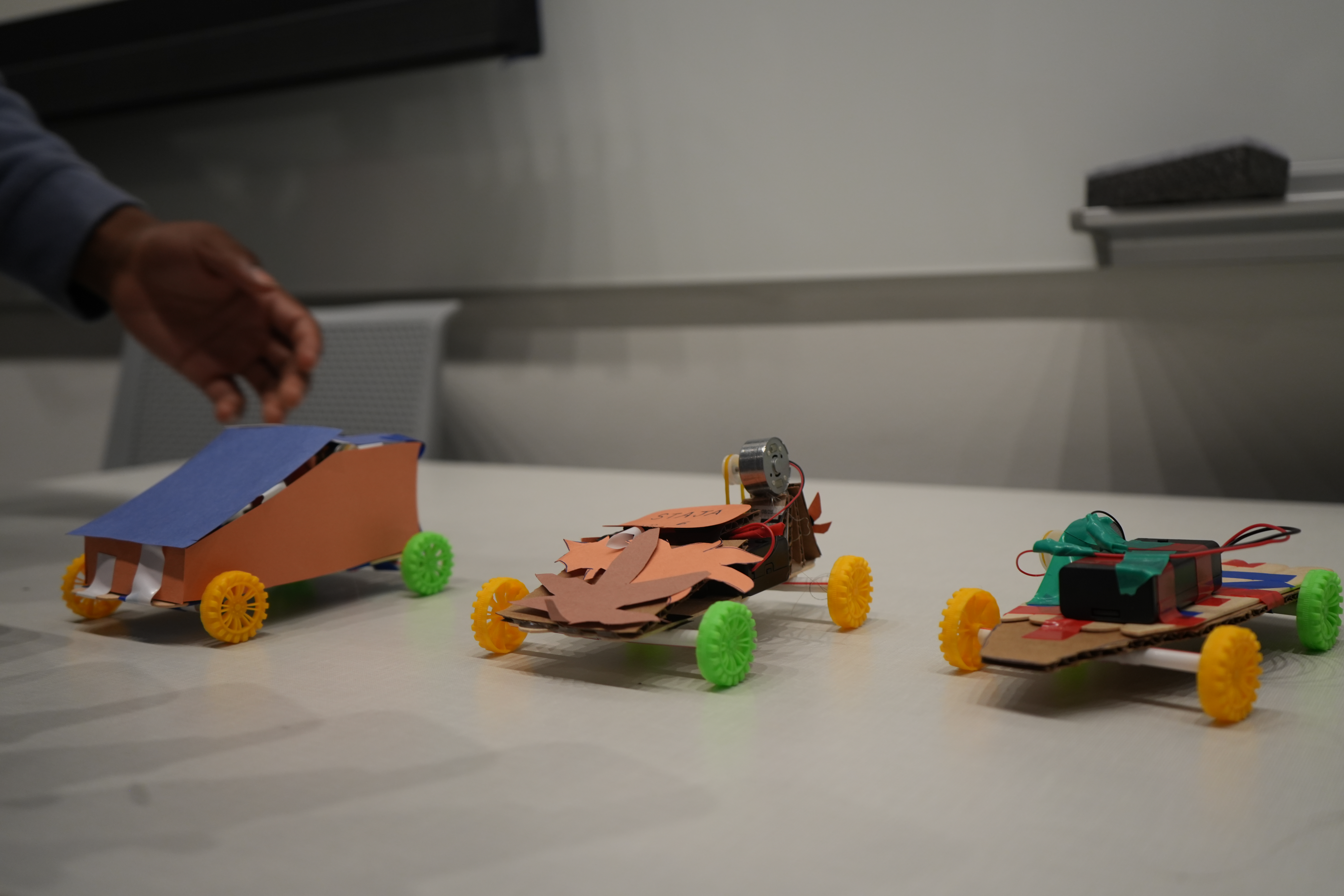 Three miniture cars designed with paper.