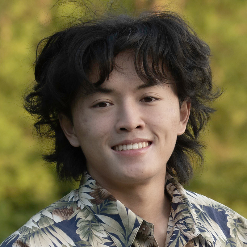 A man outside with a colorful shirt