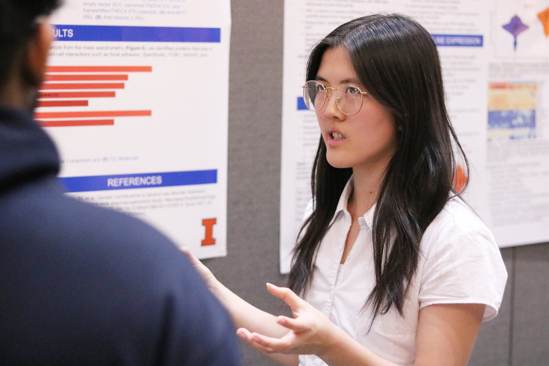 A student stands in front of a poster