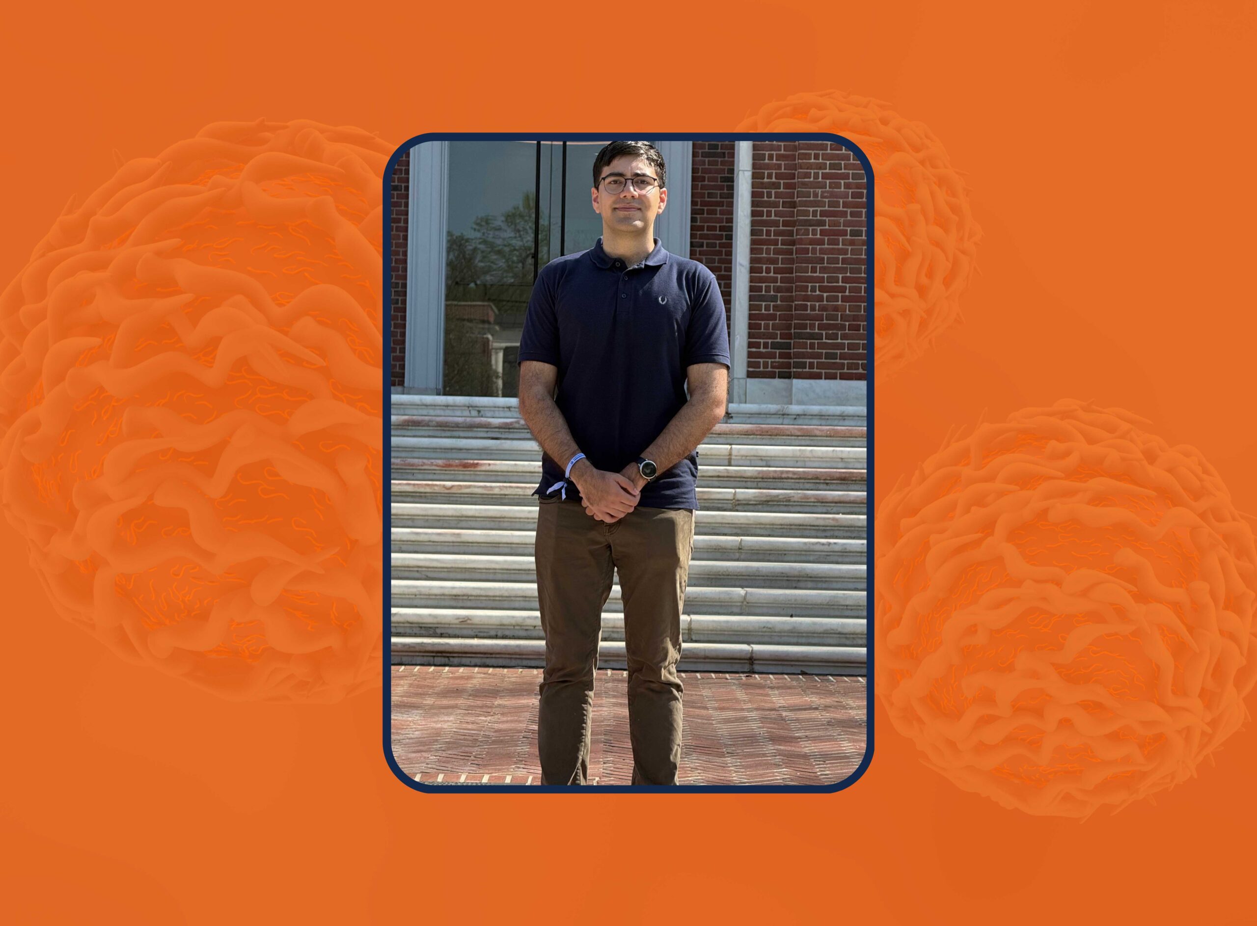 A well dressed student stands outdoors in front of a staircase