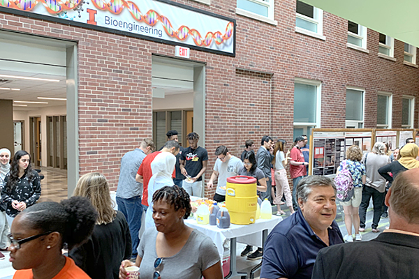 2019 WYSE high school students and visitors enjoy refreshments during a poster session.