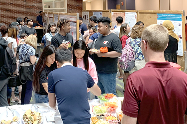 High school students discuss their 2019 WYSE research with other participants and UI faculty, staff and students.
