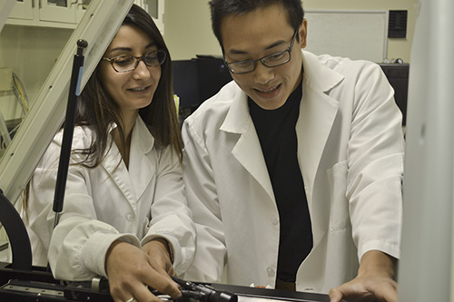 two researchers in lab coats work