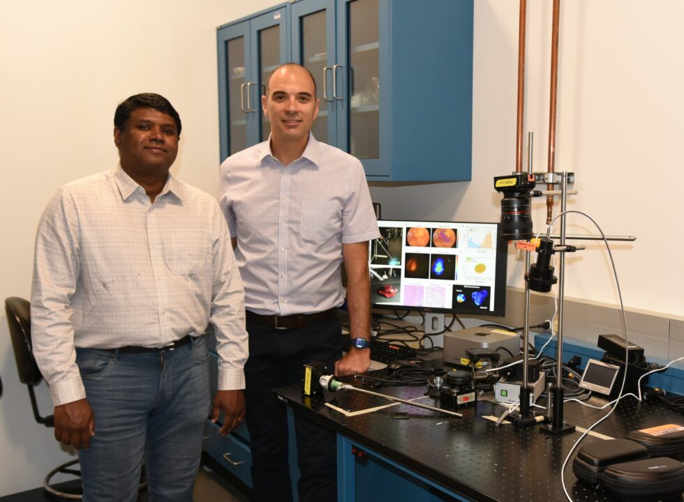 <em>Graduate Student Mebin George and CCIL Member Viktor Gruev with their novel endoscopic imaging system.</em>