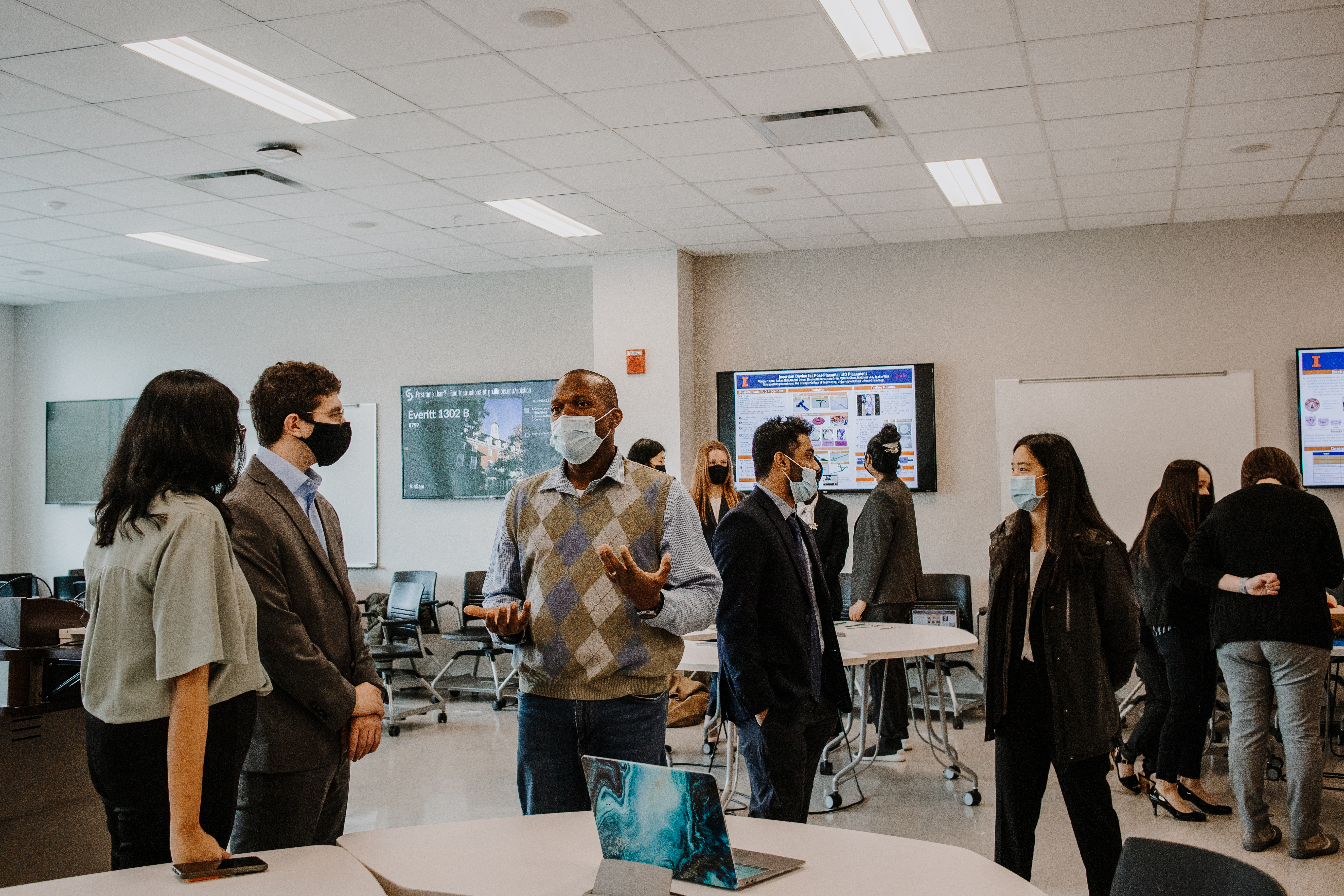 Professor Bradley (center) speaks with students during the spring '22 capstone class.