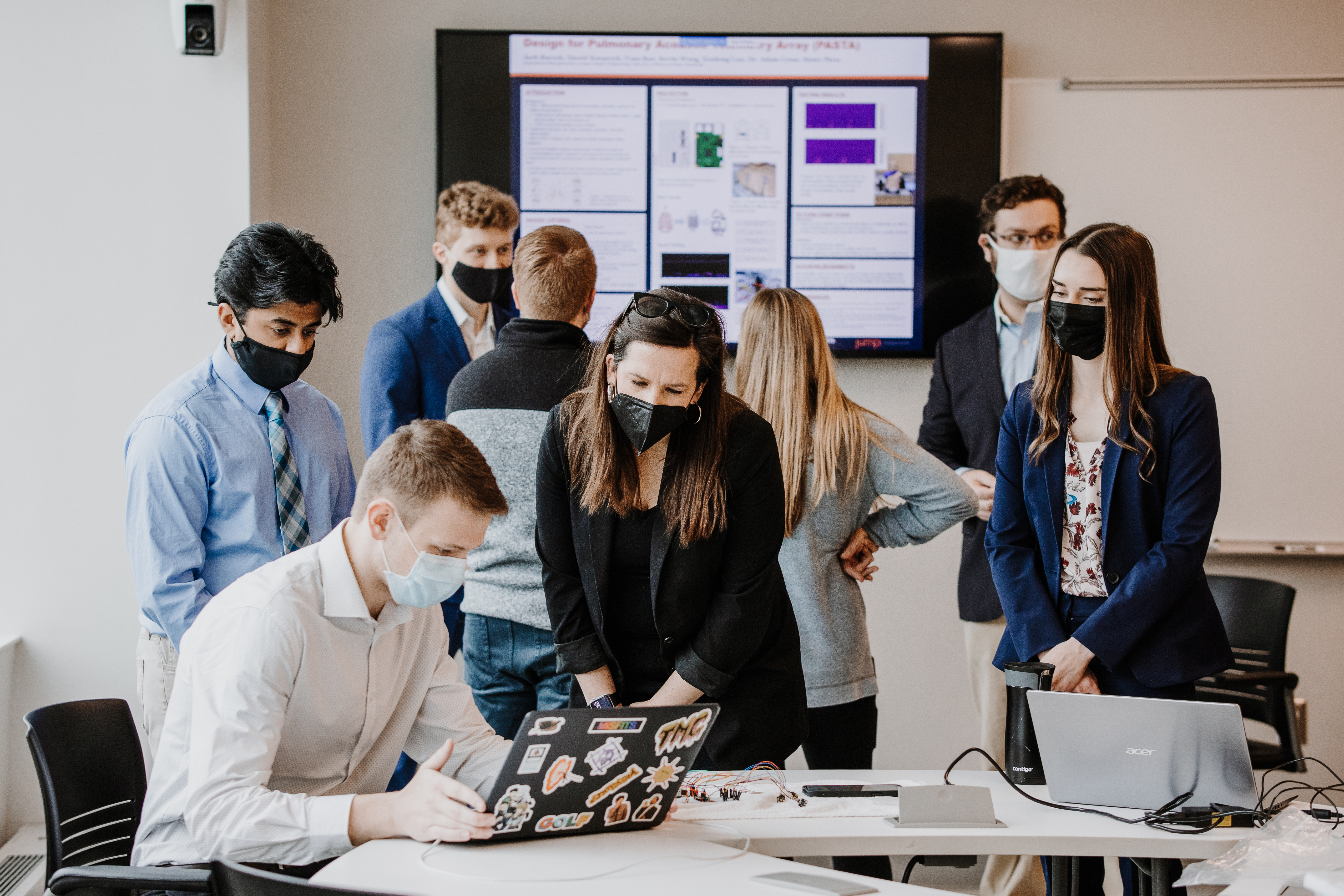 Professor Golecki (center) assists a student during the spring '22 capstone class