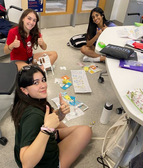 Power of Bioengineering campers building their own  foldscopes â€“ which are powerful medical-grade microscopes made from paper and lenses.