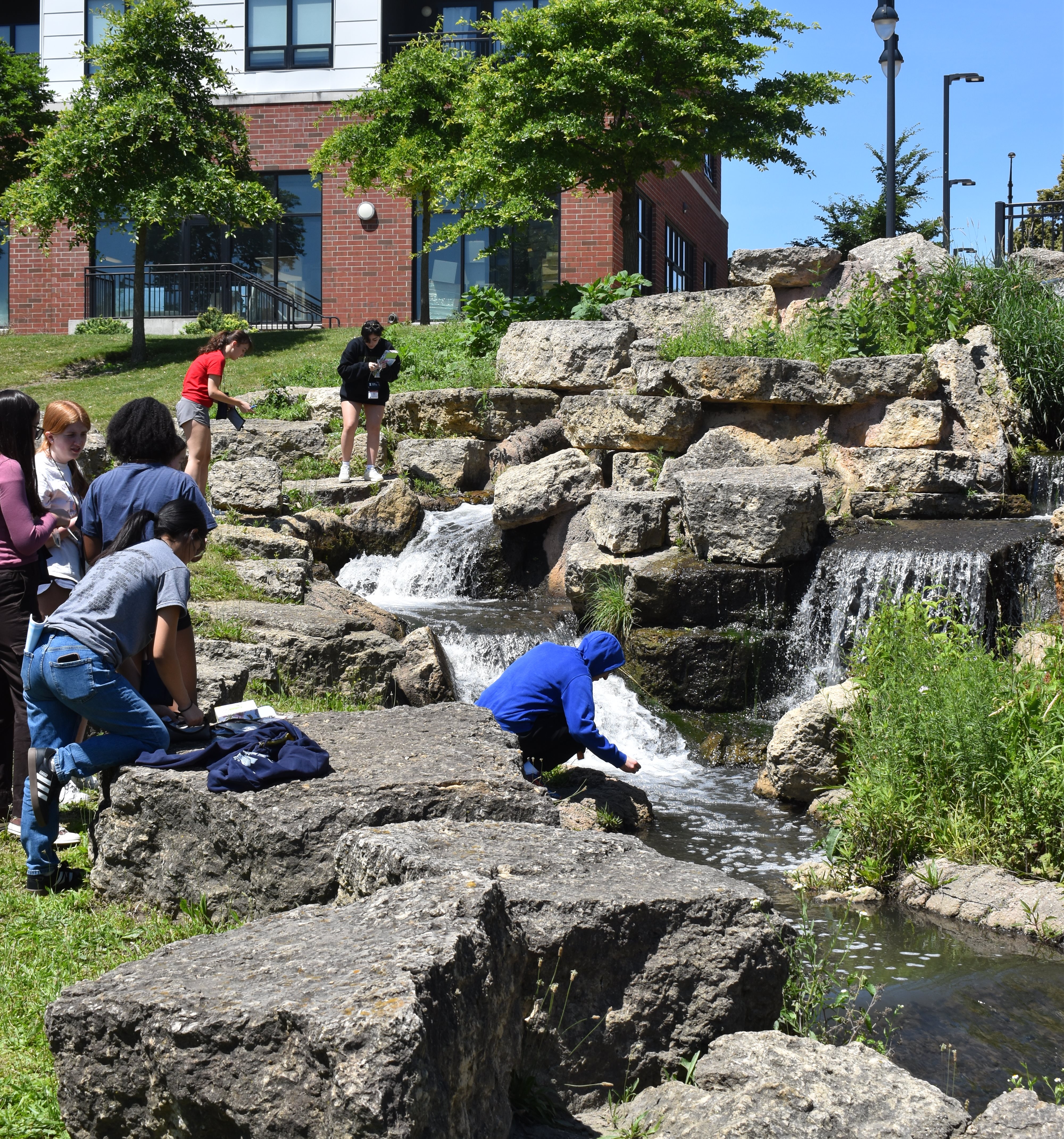 Campers collect samples along the Boneyard Creek.